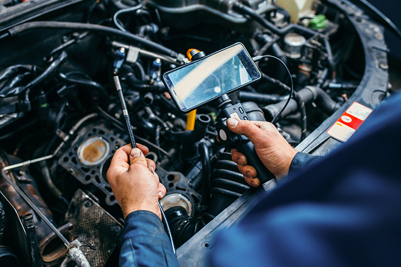 Chevrolet technician performing summer maintenance on a Chevy vehicle.